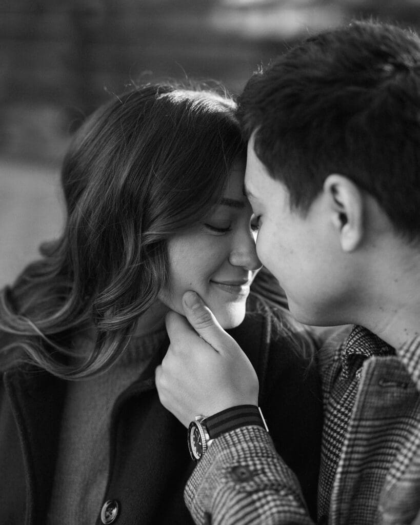 Couple leaning in together with their foreheads touching during their engagement shoot