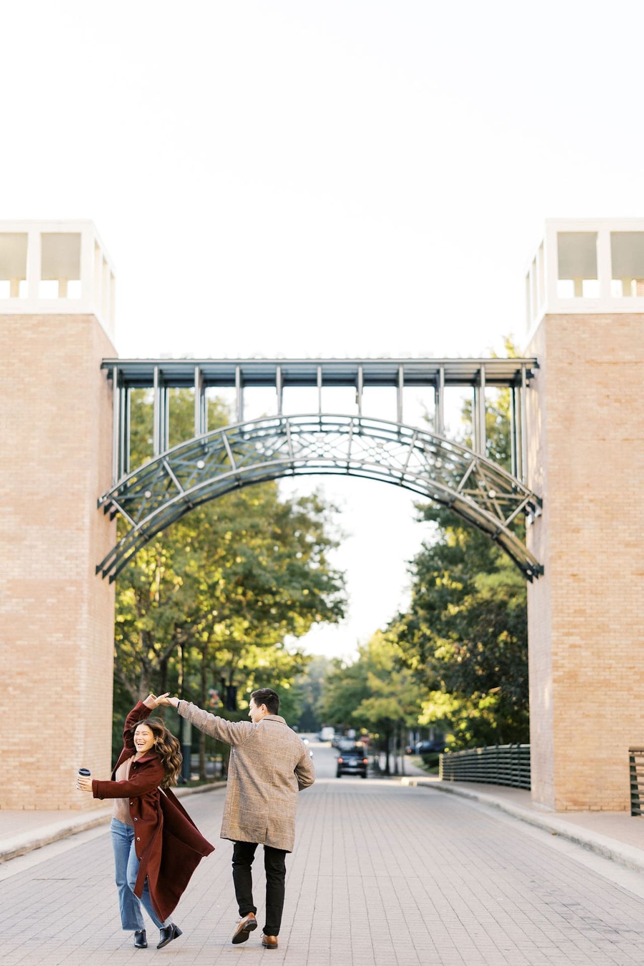 Romantic Engagement Photo Ideas, a couple dancing in the street during their sunrise engagement shoot at The Woodlands of Texas