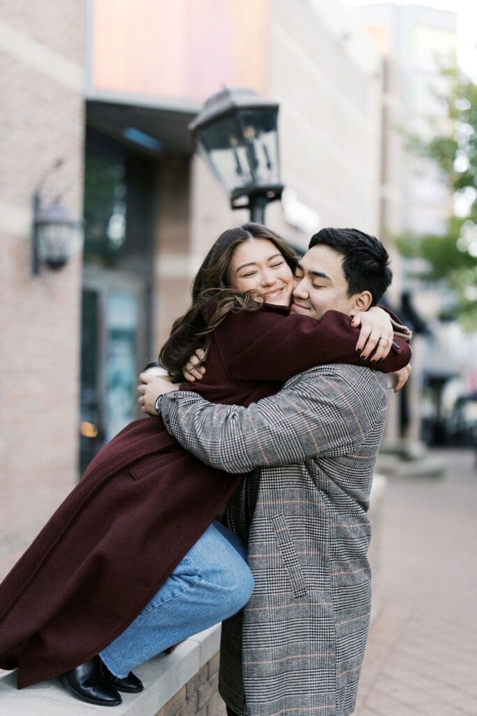 A girl hugging onto her fiance for a fun photo during their engaement photoshoot