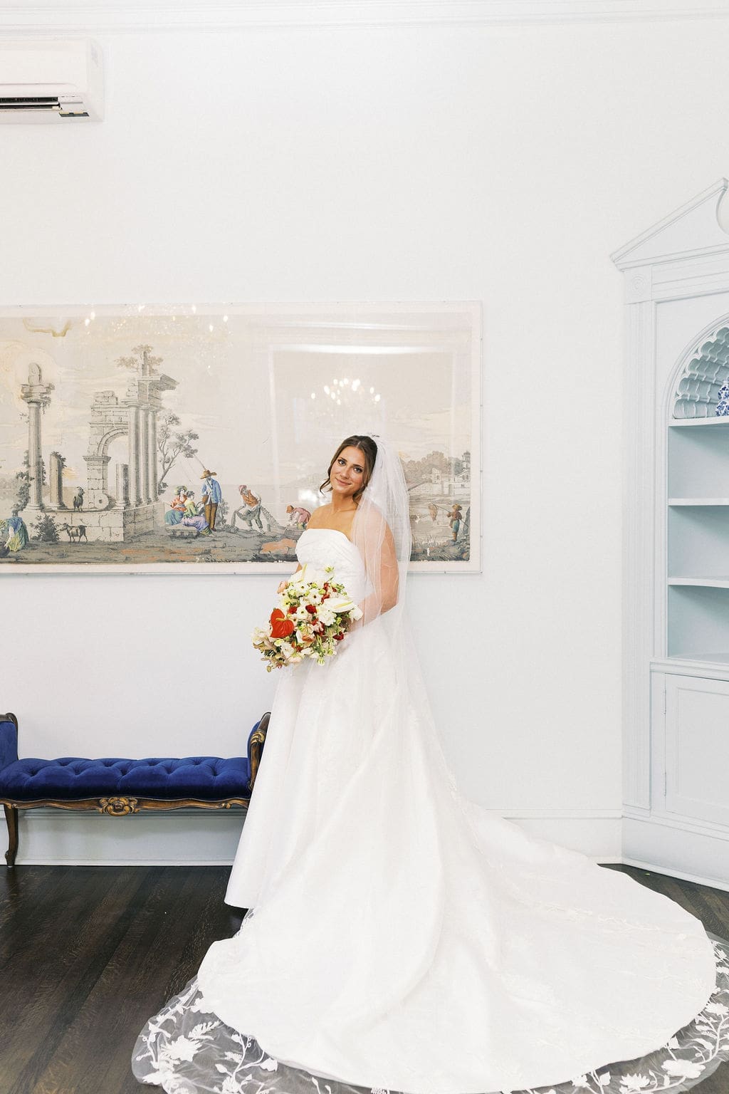 Elegant bride and groom portraits at the Woodbine Mansion. The bride holding her bouquet and smiling at the camera.