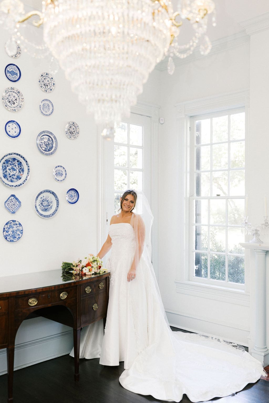 A bridal portrait at Woodbine Mansion in Texas o fher smiling softly at the photographer