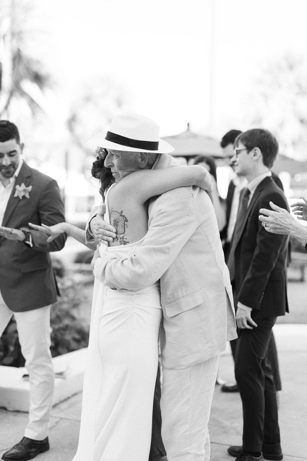 Bride hugging an older family member during an intimate destination elopement private vow ceremony, capturing emotional moments from a destination elopement with loved ones present.
