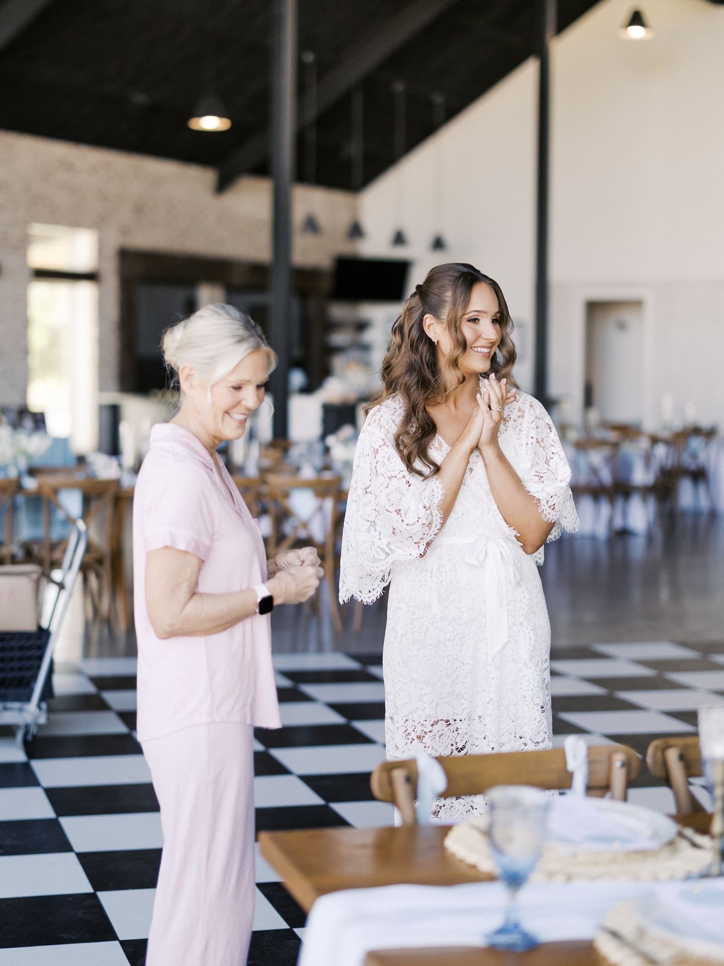 A candid photo of the bride and her mom in the reception area before they get ready at Camp Hosea.