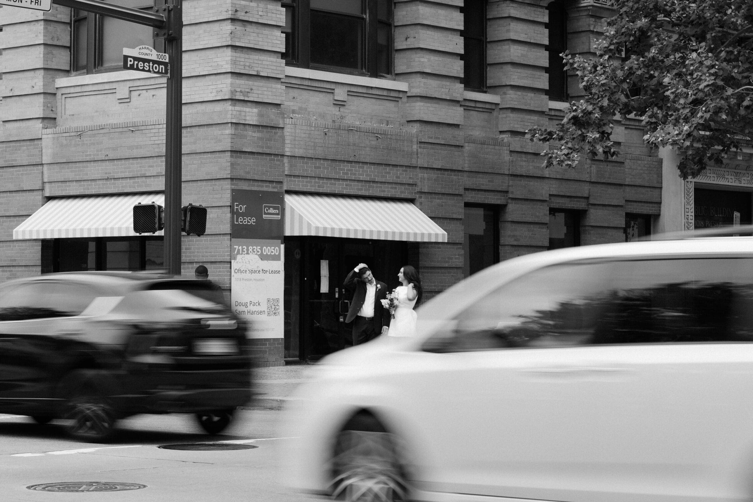 A bride and groom share a quiet moment outside a brick building on Preston Street during their courthouse wedding in Houston