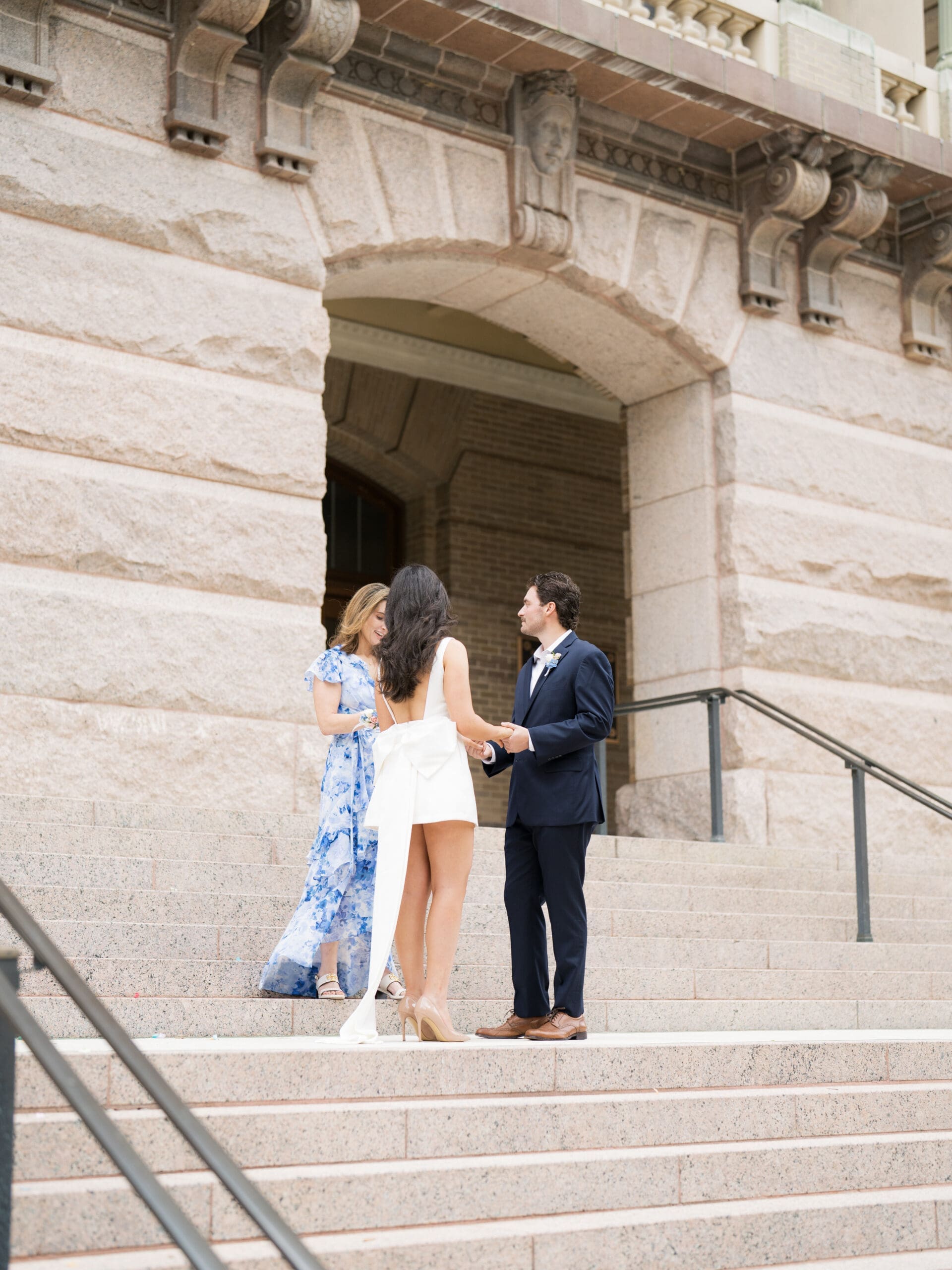 Couple exchanging vows on the steps of the Harris County courthouse during their courthouse wedding in Houston
