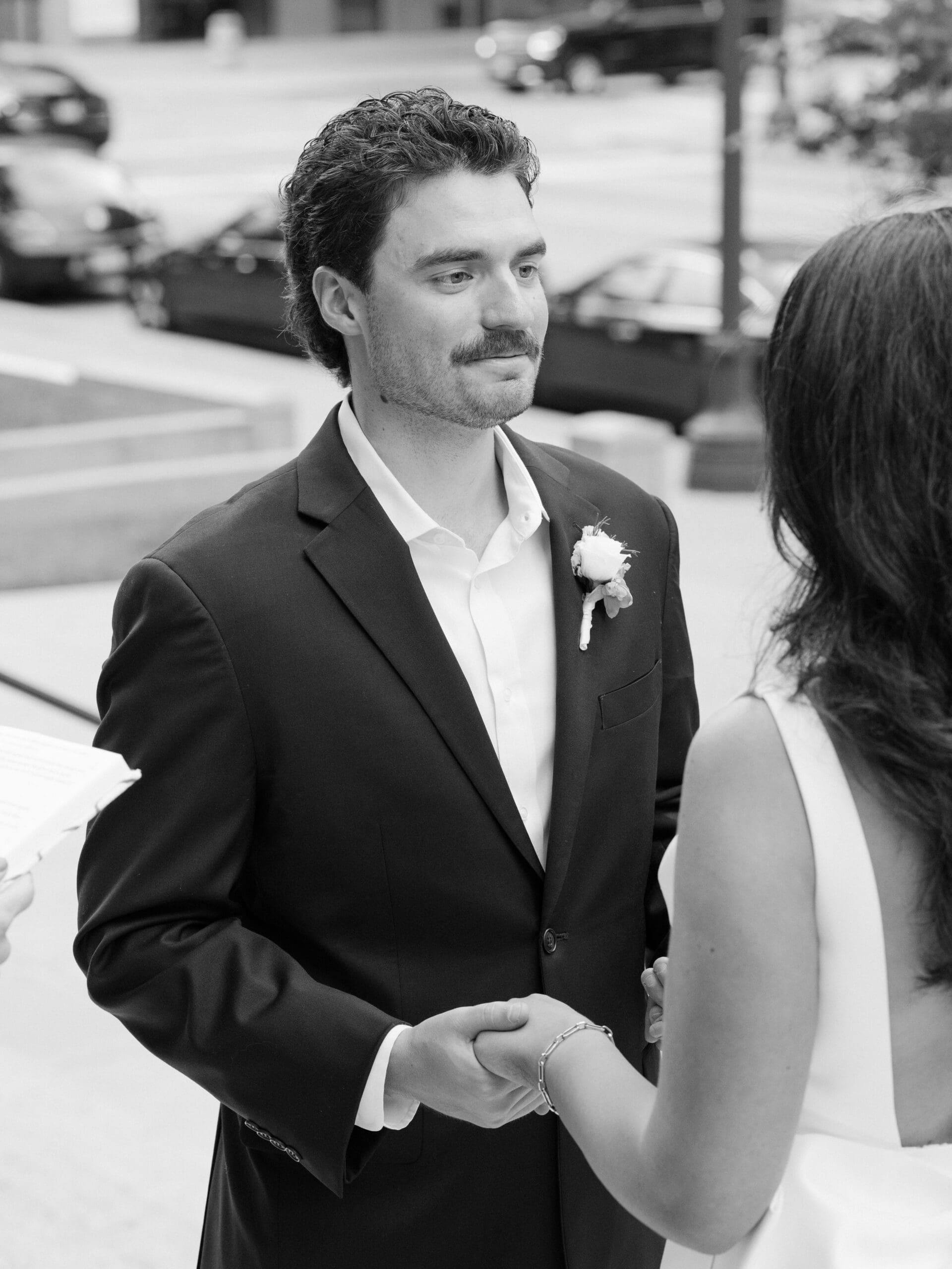 Close-up portrait of a groom looking at his bride during the wedding ceremony
