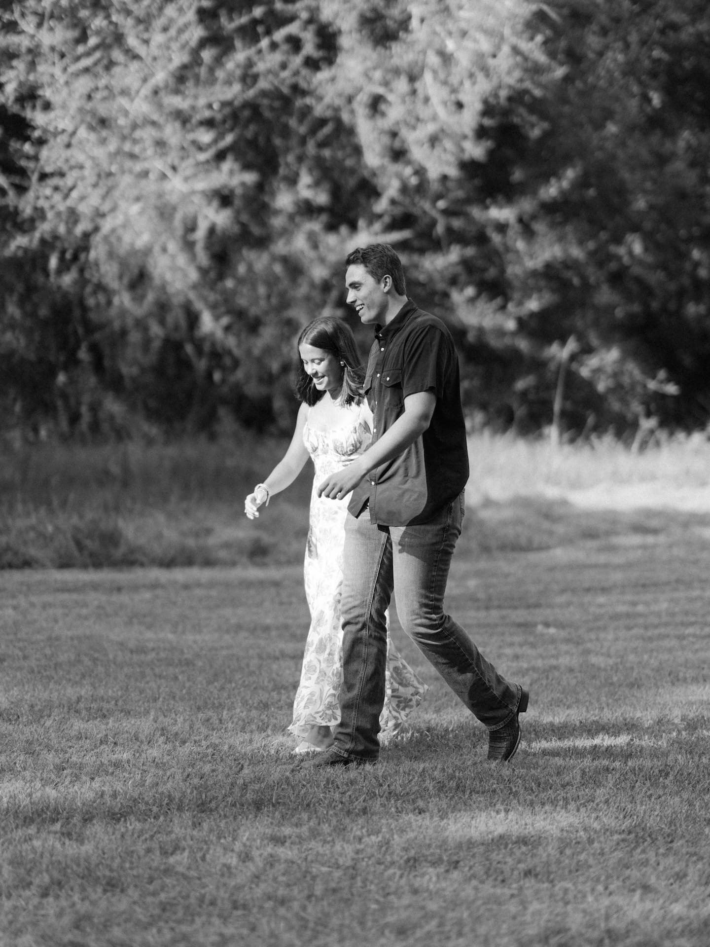 Surprise Engagement Proposal Ideas captured in black and white as a couple walks hand in hand.