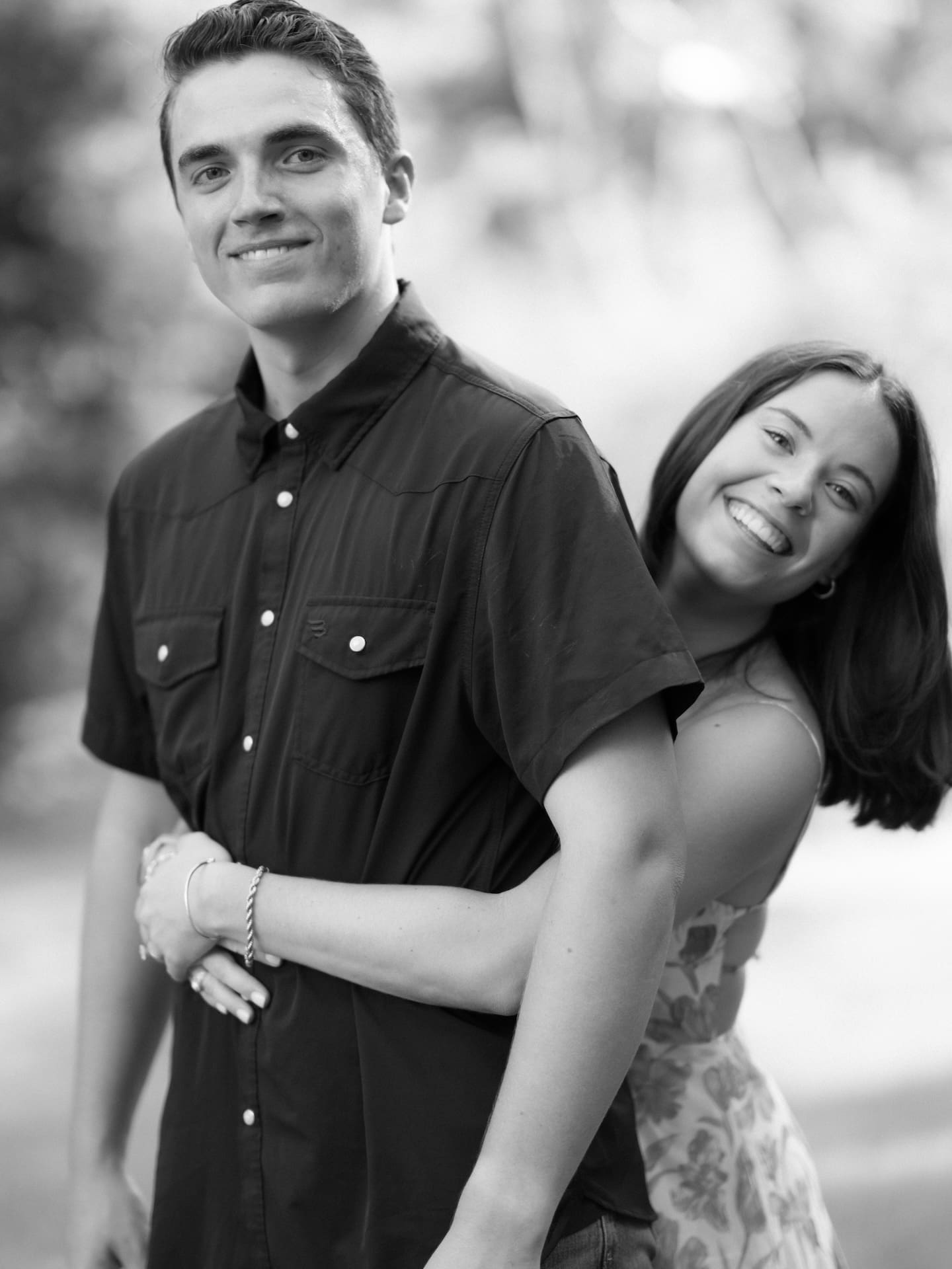 Surprise Engagement Proposal Ideas captured in black and white as a couple embraces and sways together.