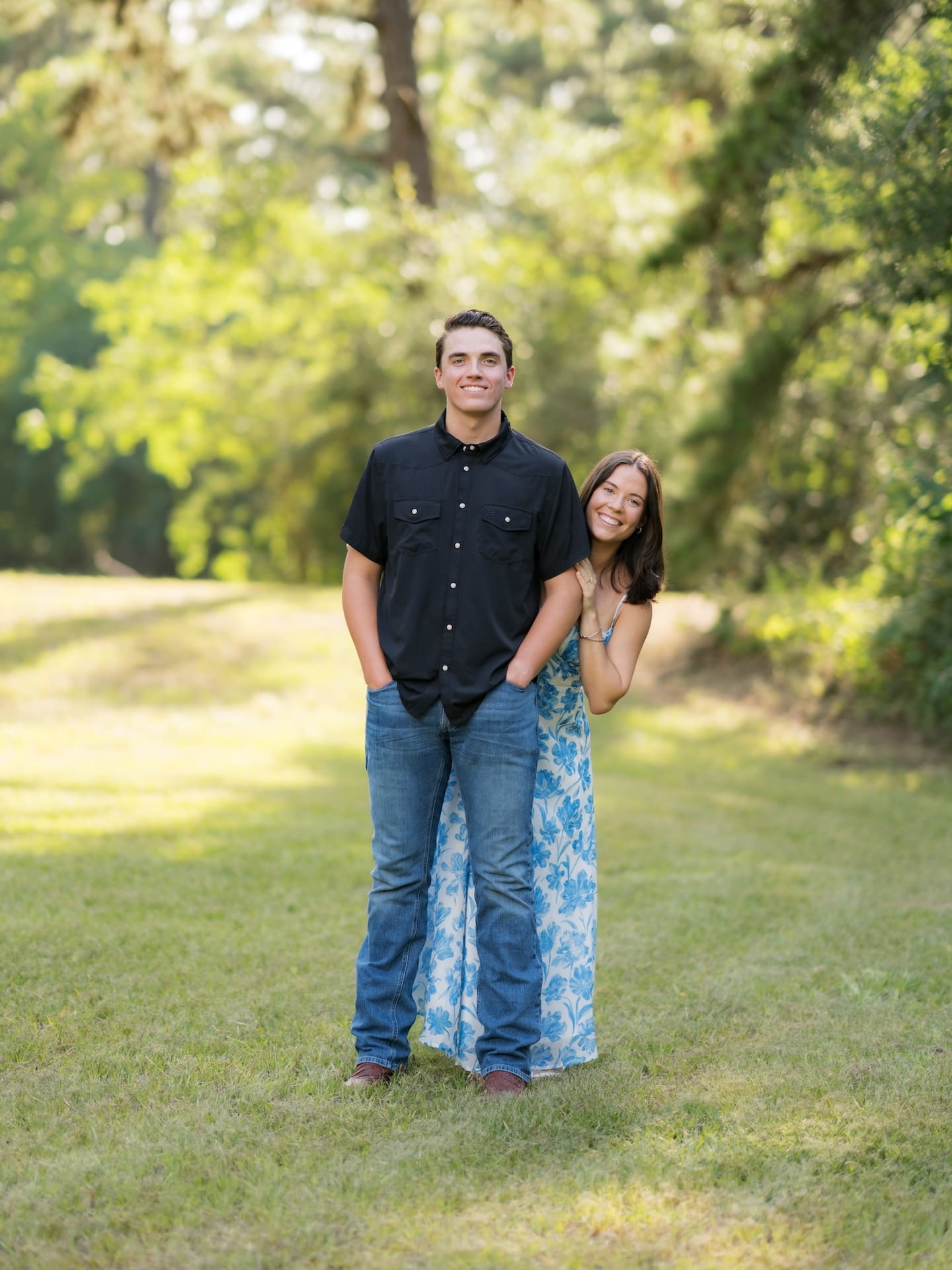 Surprise Engagement Proposal Ideas featuring a smiling couple standing close together outdoors.