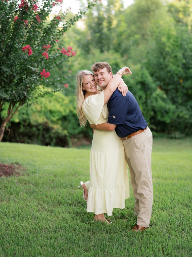Joyful, laughing embrace with the bride-to-be kicking up her heel, from a Brenners on the Bayou proposal photography session